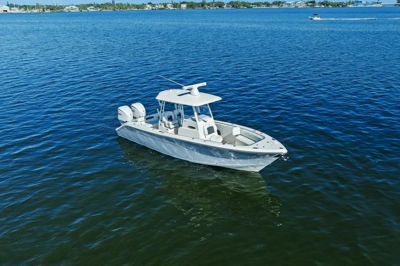 Slide: The Image of 2023 Cobia 301 Center Console boat on calm blue water. - 36