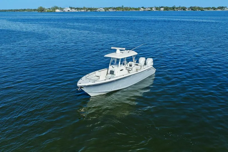 Slide: The Image of 2023 Cobia 301 Center Console boat on calm blue water. - 37