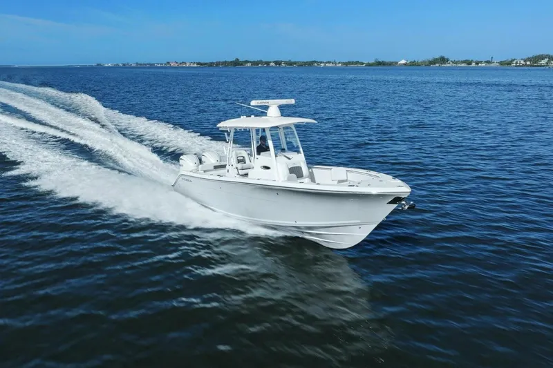 Slide: The Image of 2023 Cobia 301 Center Console boat cruising on open water. - 4