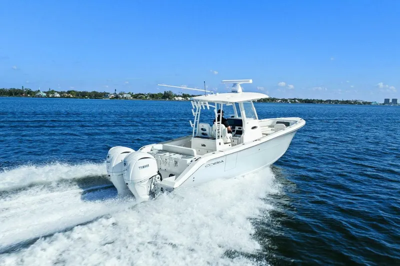 Slide: The Image of 2023 Cobia 301 Center Console boat cruising on open water. - 40