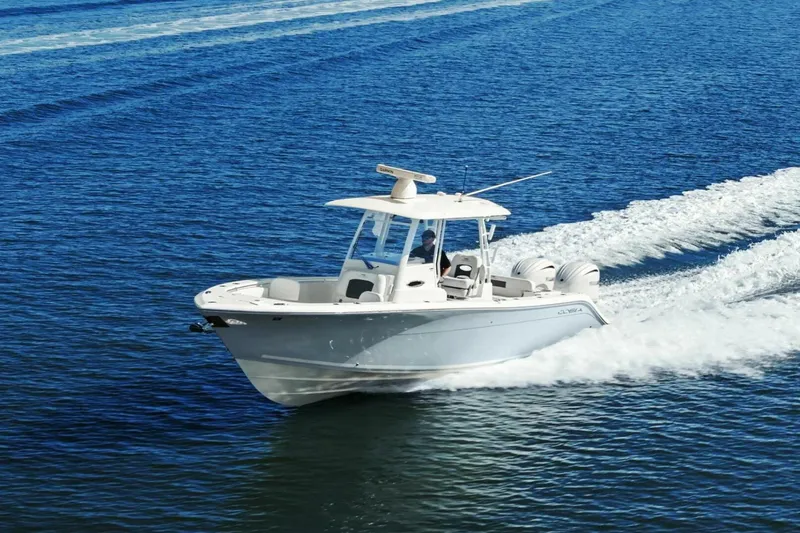 Slide: The Image of 2023 Cobia 301 Center Console boat cruising on open water. - 43