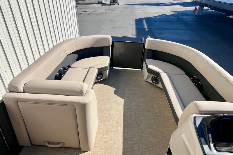 Slide: The Image of 2025 Harris Cruiser 230 boat interior with beige seating and cup holders. - 11