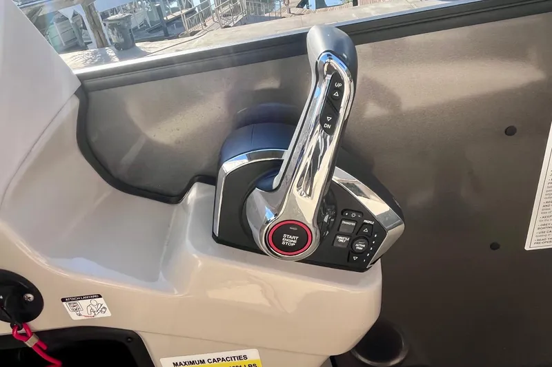 Slide: The Image of Throttle control panel of 2025 Harris Cruiser 230 boat, featuring start/stop button and control switches. - 13