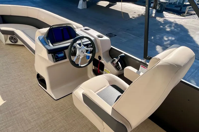 Slide: The Image of 2025 Harris Cruiser 230 boat interior with modern helm and comfortable seating. - 14