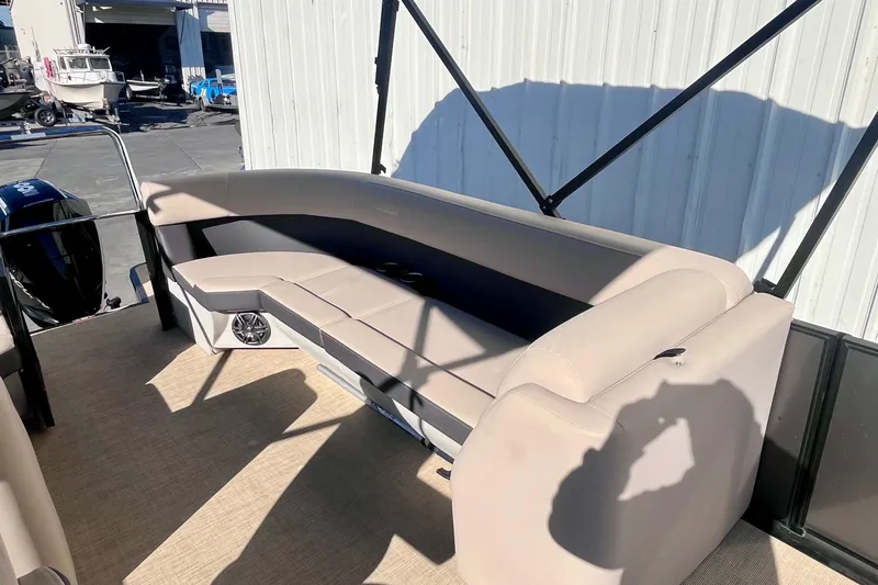 Slide: The Image of 2025 Harris Cruiser 230 pontoon boat with beige seating and spacious deck area. - 15