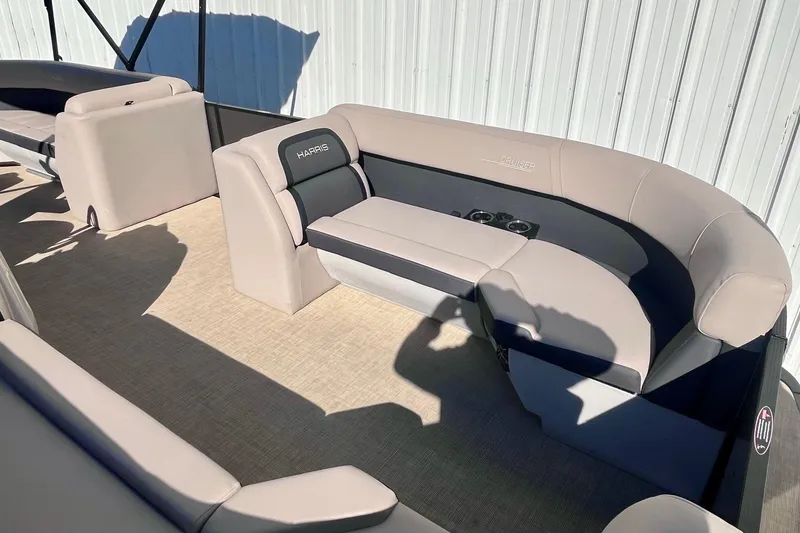 Slide: The Image of 2025 Harris Cruiser 230 boat interior with plush seating and cup holders. - 8