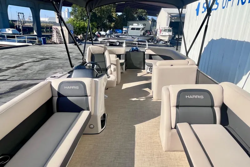 Slide: The Image of 2025 Harris Cruiser 230 pontoon boat with spacious seating and modern design. - 9