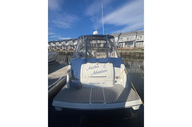 Slide: The Image of 2006 Formula 34 Performance Cruiser docked near waterfront homes under blue sky. - 11