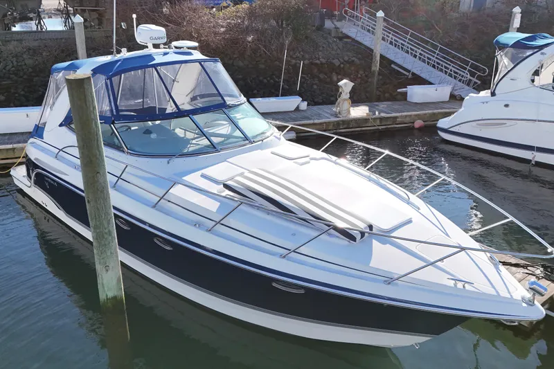 Slide: The Image of 2006 Formula 34 Performance Cruiser docked at marina, featuring sleek design and blue accents. - 2