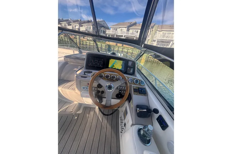 Slide: The Image of 2006 Formula 34 Performance Cruiser helm with Garmin navigation, docked near waterfront homes. - 21