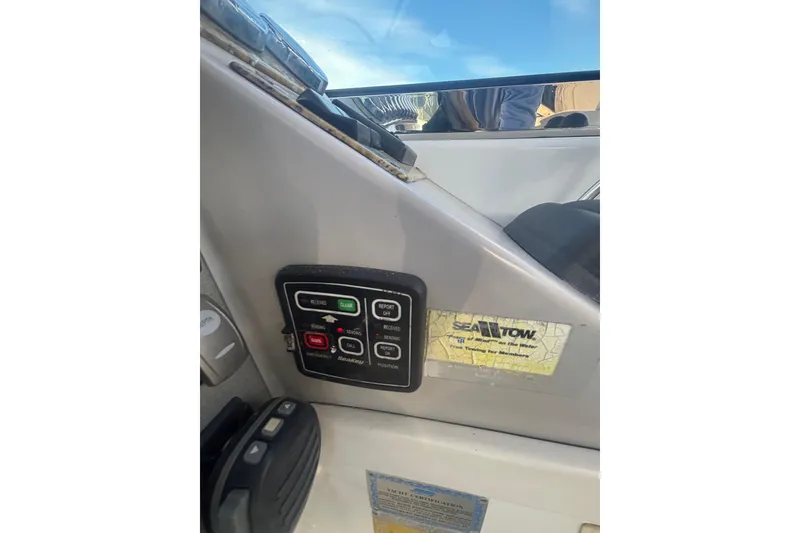 Slide: The Image of 2006 Formula 34 Performance Cruiser helm with controls and gauges, overlooking water. - 25