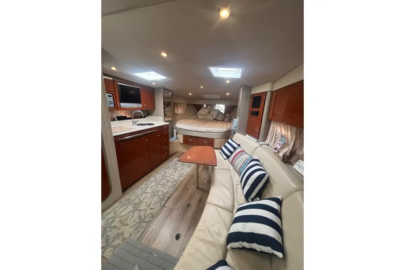 Slide: The Image of Interior of 2006 Formula 34 Performance Cruiser with beige seating and mounted TV. - 34