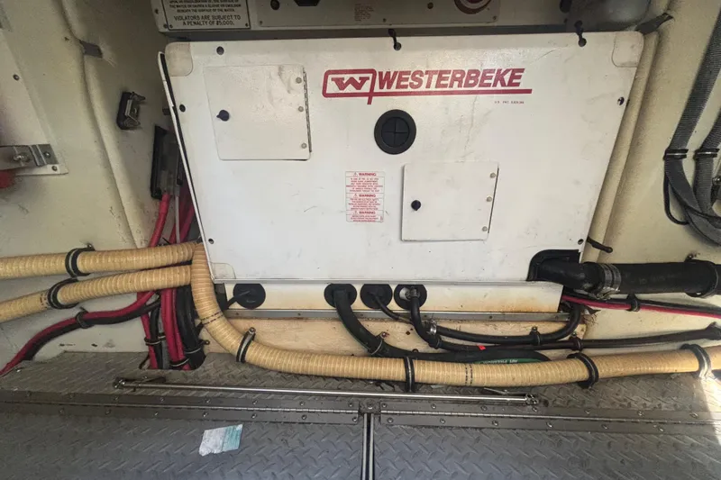 Slide: The Image of Engine compartment of a 2006 Formula 34 Performance Cruiser with visible wiring and components. - 49