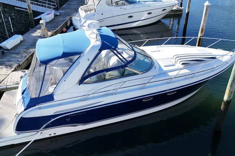 Slide: The Image of 2006 Formula 34 Performance Cruiser docked at marina, featuring sleek design and blue accents. - 6