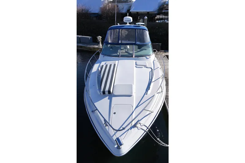 Slide: The Image of 2006 Formula 34 Performance Cruiser docked at marina, featuring blue and white design. - 7