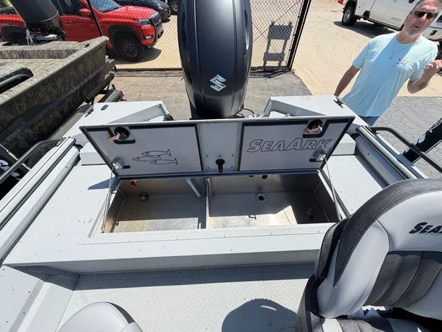 Slide: The Image of 2026 SeaArk Protege 200 boat with open storage compartment lid. - 17