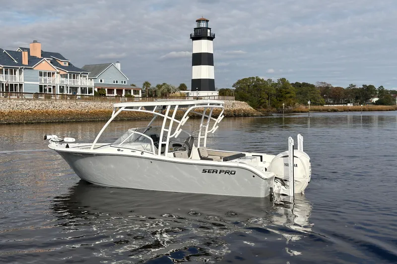 The Image of Seapro 240 DLX 2025 boat near lighthouse and houses. - 0