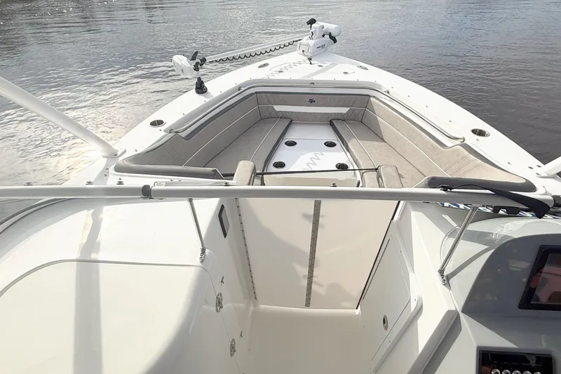 Slide: The Image of 2025 Seapro 240 DLX boat interior with cushioned seating and water view. - 10