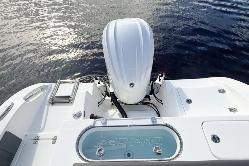 Slide: The Image of 2025 Seapro 240 DLX boat with outboard motor on calm water. - 13