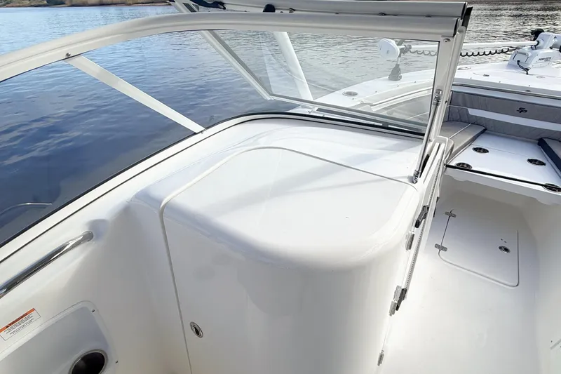 Slide: The Image of 2025 Seapro 240 DLX boat interior with sleek white design and spacious seating. - 15
