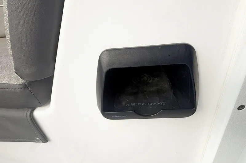 Slide: The Image of Wireless charging station on 2025 Seapro 240 DLX boat interior. - 19
