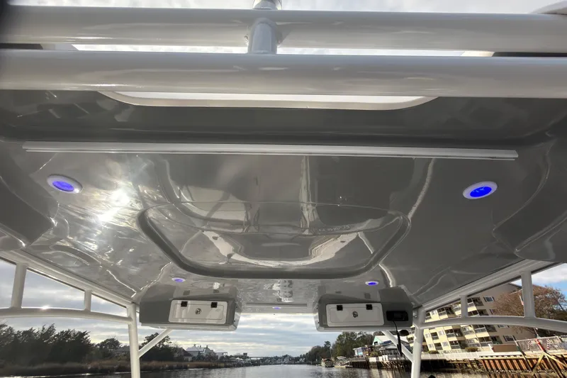 Slide: The Image of 2025 Seapro 240 DLX boat roof with blue LED lights and sleek design. - 24