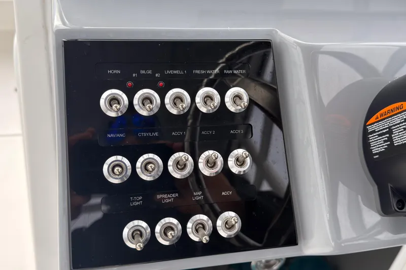 Slide: The Image of Control panel of 2025 Seapro 240 DLX boat with labeled switches. - 30