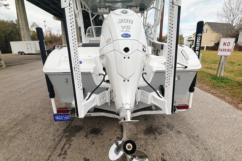 Slide: The Image of 2025 Seapro 240 DLX boat with powerful 300 V6 engine, parked on a street. - 7
