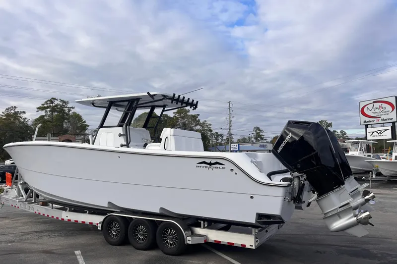 The Image of 2026 Invincible 33 Catamaran on trailer, featuring dual Mercury outboard engines. - 0