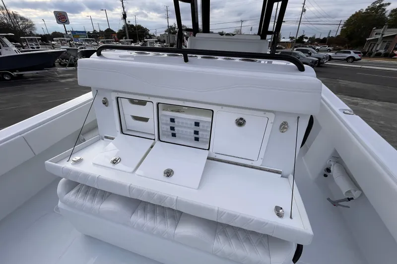 Slide: The Image of 2026 Invincible 33 Catamaran interior with storage compartments and seating, docked outdoors. - 11