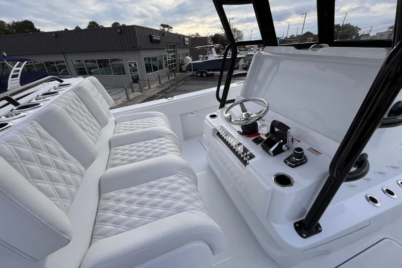 Slide: The Image of 2026 Invincible 33 Catamaran interior with plush seating and modern helm controls. - 13