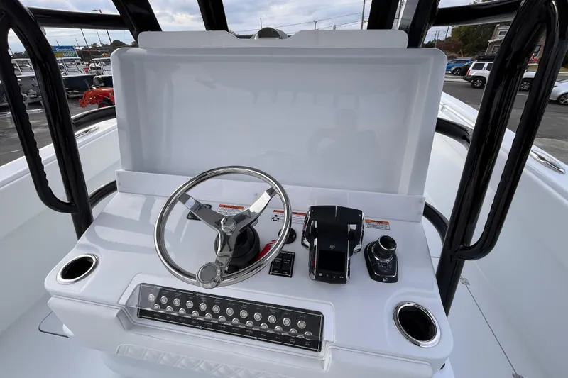 Slide: The Image of 2026 Invincible 33 Catamaran helm with steering wheel and controls. - 15