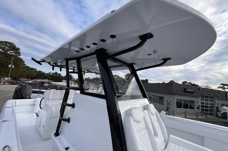 Slide: The Image of 2026 Invincible 33 Catamaran with sleek design and modern seating, docked outdoors. - 17