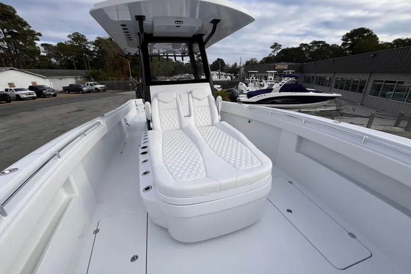 Slide: The Image of 2026 Invincible 33 Catamaran with luxurious white seating, docked at a marina. - 22