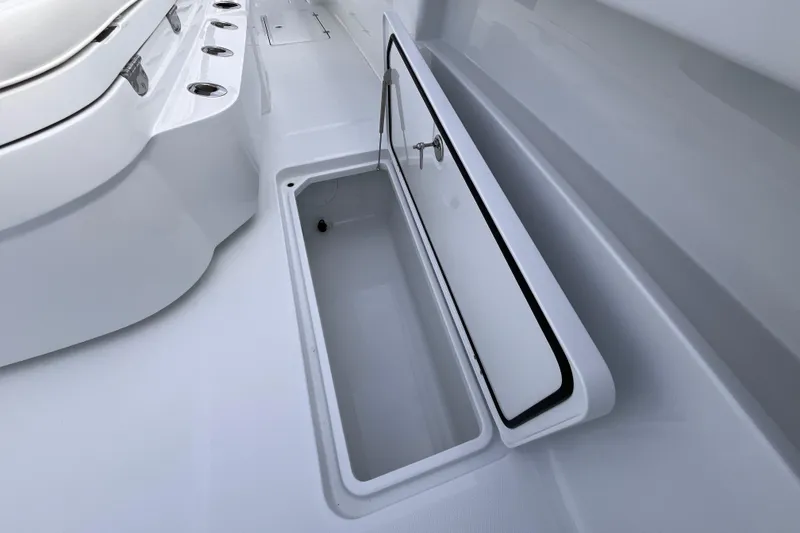 Slide: The Image of 2026 Invincible 33 Catamaran storage compartment with open hatch, showcasing sleek design. - 23