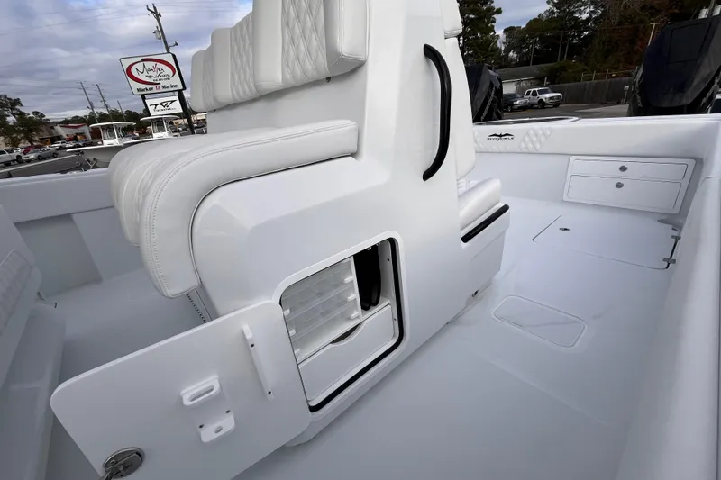 Slide: The Image of 2026 Invincible 33 Catamaran interior with white seating and storage compartments. - 27