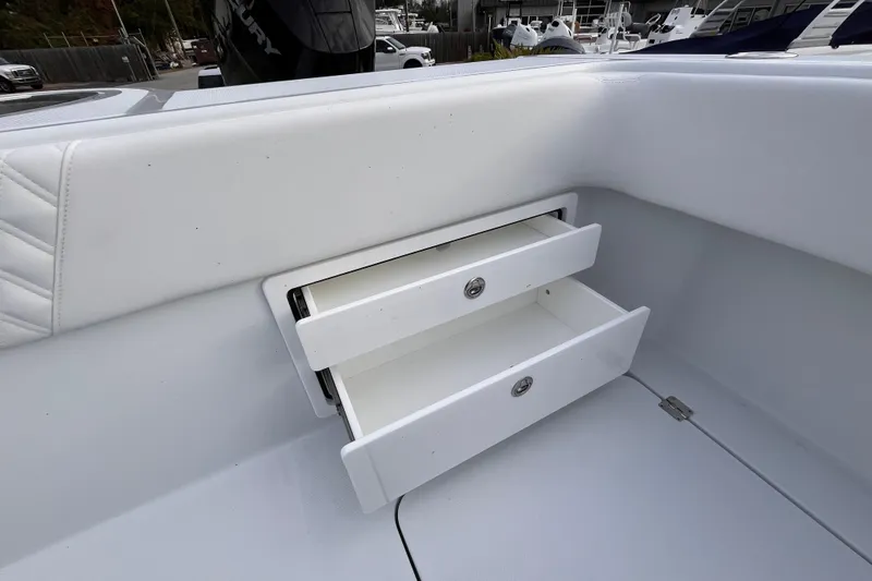 Slide: The Image of Open storage drawers on a 2026 Invincible 33 Catamaran boat interior. - 30