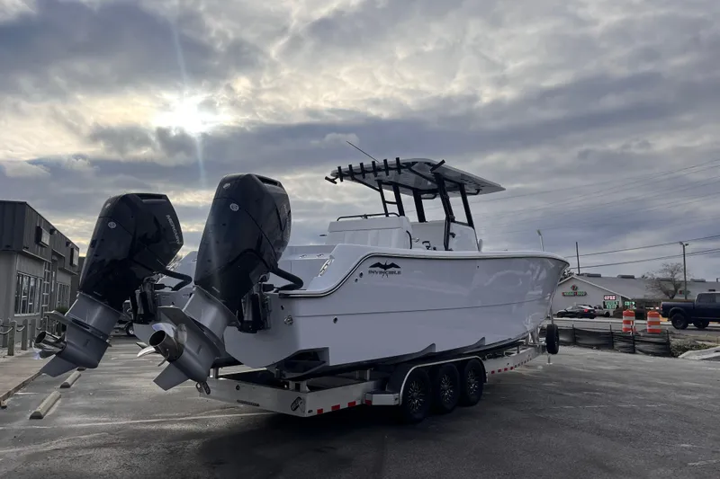 Slide: The Image of 2026 Invincible 33 Catamaran with dual engines on a trailer under cloudy sky. - 4