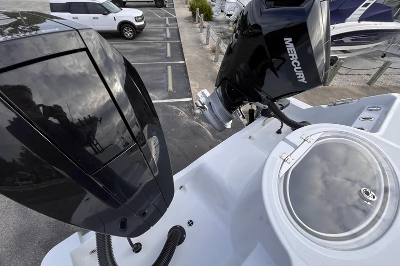 Slide: The Image of 2026 Invincible 33 Catamaran with Mercury outboard engines in a marina setting. - 6