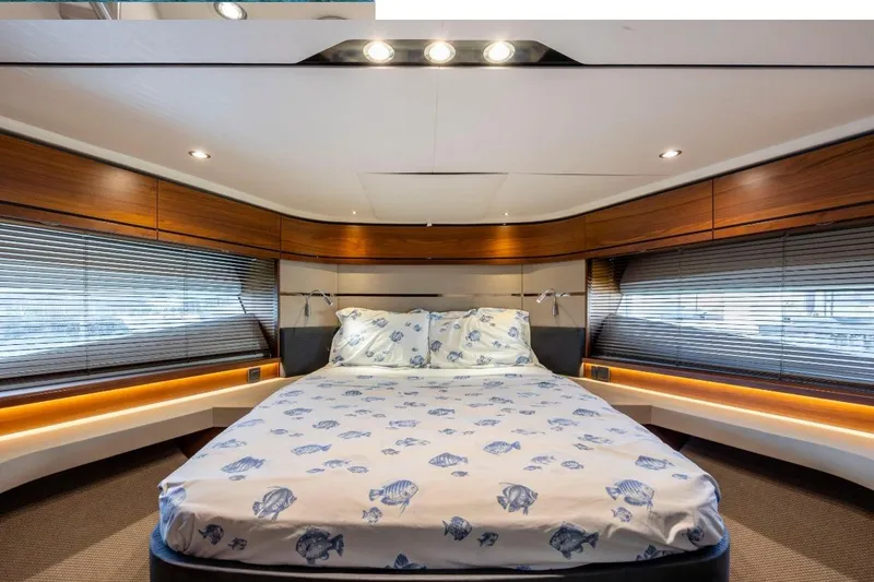 Slide: The Image of Luxurious 2017 Princess S65 yacht bedroom with fish-patterned bedding and elegant wood accents. - 10