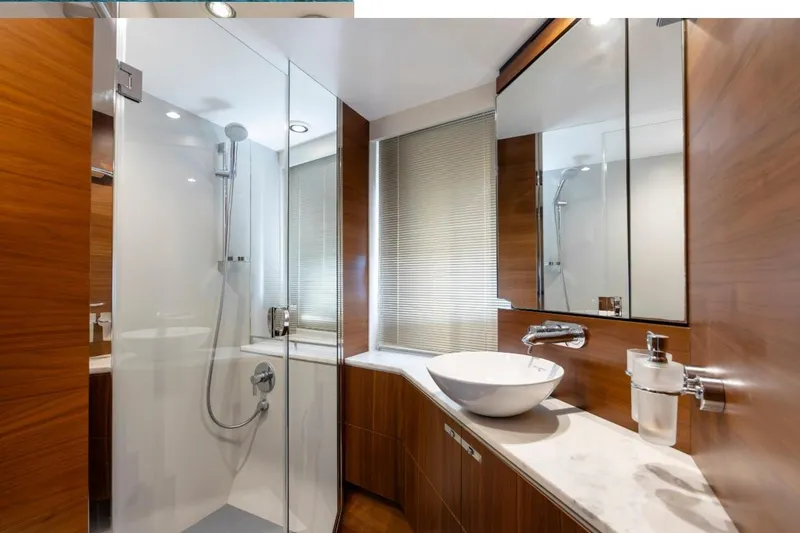 Slide: The Image of Luxurious bathroom in 2017 Princess S65 yacht with modern fixtures and wooden accents. - 12