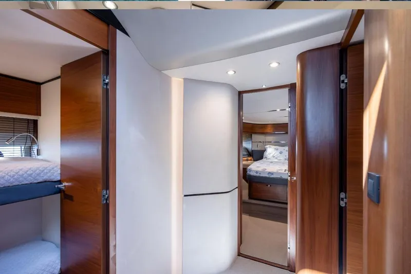 Slide: The Image of Interior of 2017 Princess S65 yacht, featuring luxurious bedrooms with wooden doors and modern lighting. - 16