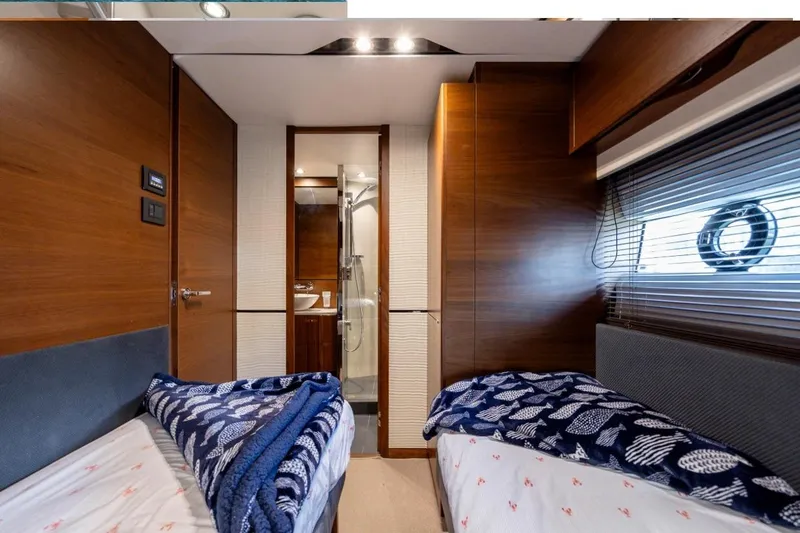 Slide: The Image of Luxurious 2017 Princess S65 yacht cabin with twin beds and modern ensuite bathroom. - 21
