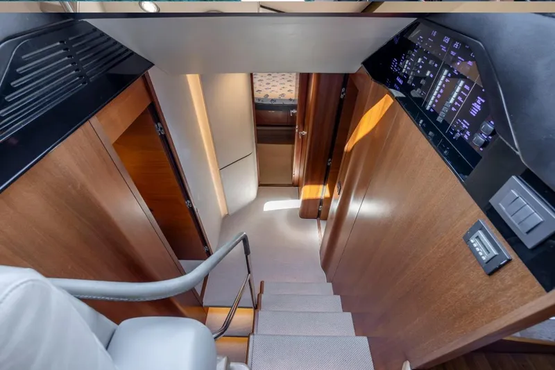 Slide: The Image of Staircase in 2017 Princess S65 yacht with wood paneling and control panel. - 9