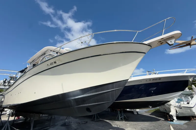 The Image of 2005 Grady-White Express 330 boat on dry dock under clear blue sky. - 0