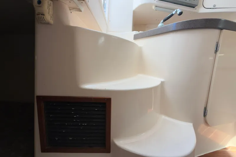 Slide: The Image of Interior stairs of a 2005 Grady-White Express 330 boat, featuring a compact design. - 16