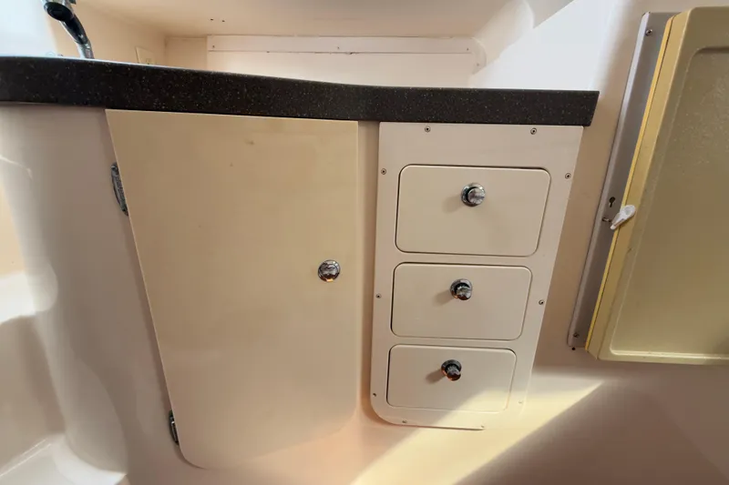 Slide: The Image of Interior storage cabinets on a 2005 Grady-White Express 330 boat. - 22