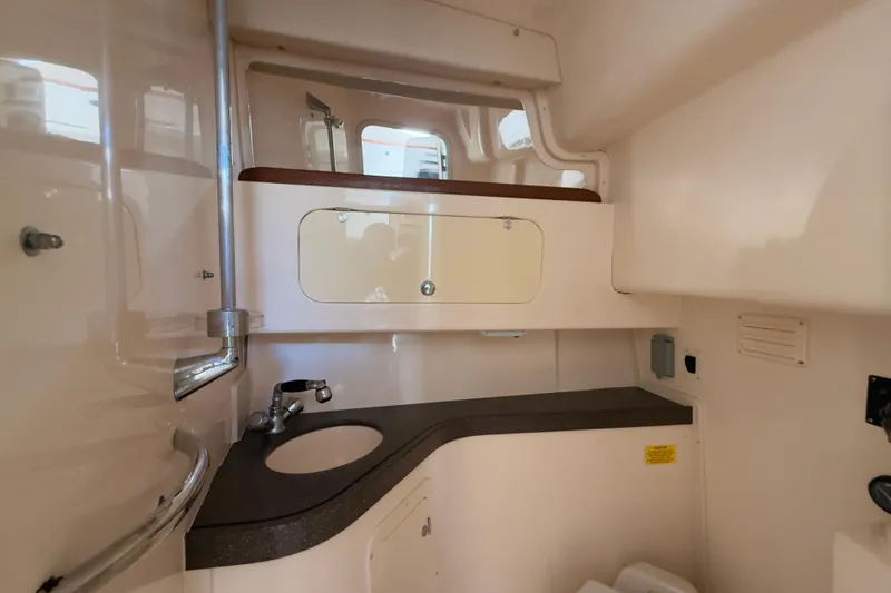 Slide: The Image of 2005 Grady-White Express 330 boat interior with sink and storage cabinet. - 26