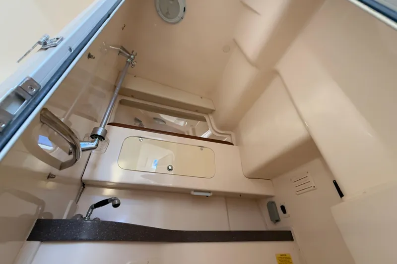 Slide: The Image of 2005 Grady-White Express 330 boat interior with sink and storage. - 27