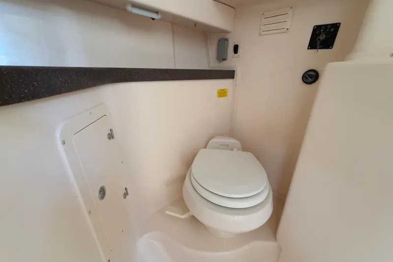 Slide: The Image of 2005 Grady-White Express 330 boat bathroom with toilet and storage compartment. - 29